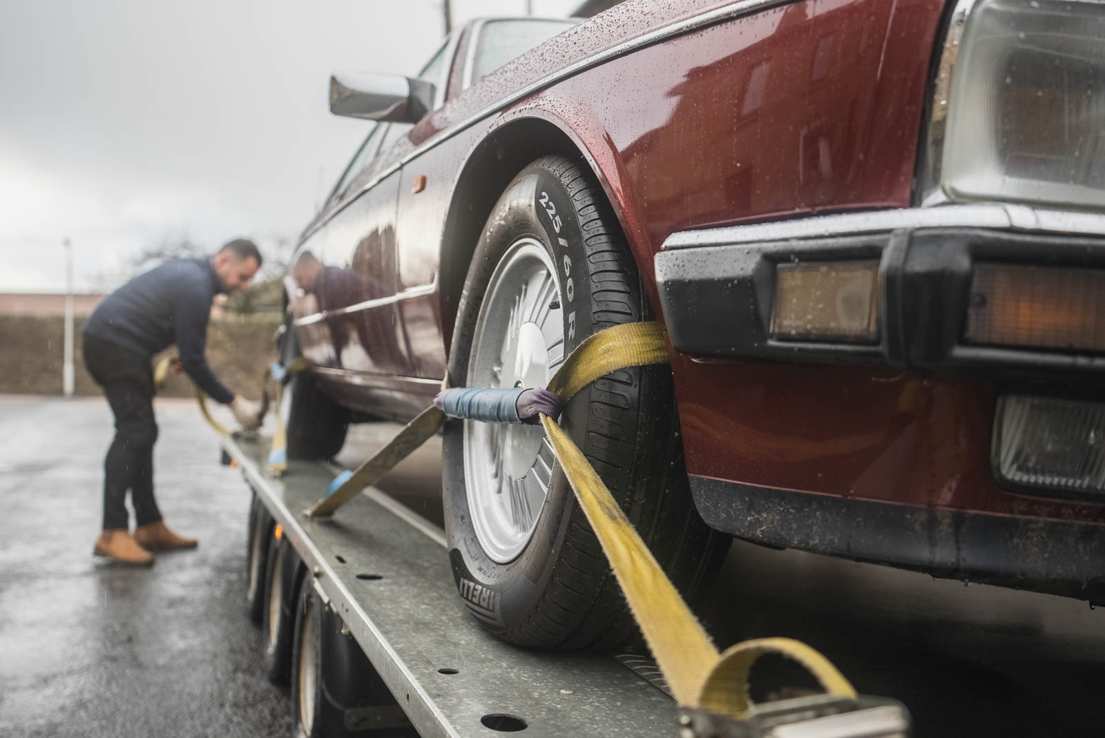 Vehicle being carefully strapped down to the HS4 Transport trailer